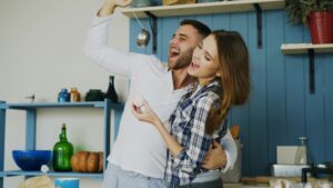 image of couple playing/being silly in a kitchen. For a relationship blog post for Core Values Counseling Portland, Or.