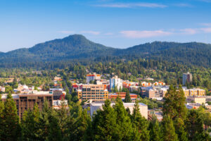 Image of the Eugene, Oregon cityscape with mountains in the background. Core Values Counseling offers virtual therapy in Eugene and throughout the state of Oregon.