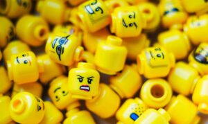 Learn how understanding emotional “parts” can help couples reduce conflict, increase compassion, and show up with calm, connection, and clarity. Image of lego parts: yellow lego "head" parts